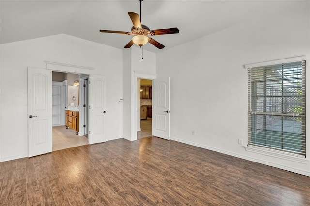 unfurnished bedroom with ensuite bath, vaulted ceiling, ceiling fan, and light wood-type flooring