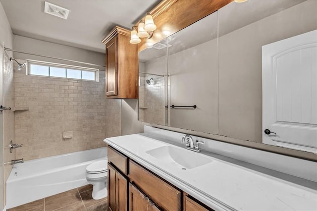 full bathroom featuring vanity, toilet, tiled shower / bath combo, and tile patterned flooring