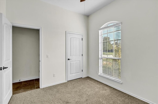 unfurnished bedroom featuring ceiling fan and carpet