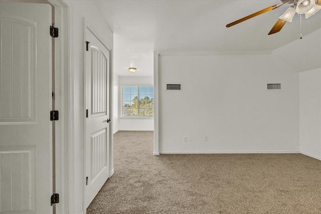 spare room with ceiling fan and carpet