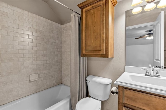 full bathroom featuring vaulted ceiling, vanity, ceiling fan, toilet, and shower / bath combo with shower curtain