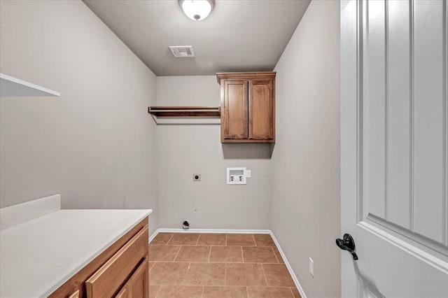 washroom with hookup for a washing machine, light tile patterned flooring, electric dryer hookup, and cabinets