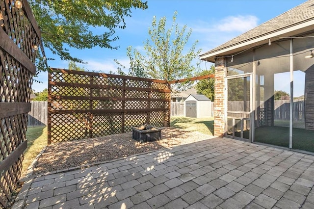 view of patio / terrace with a storage unit and a fire pit