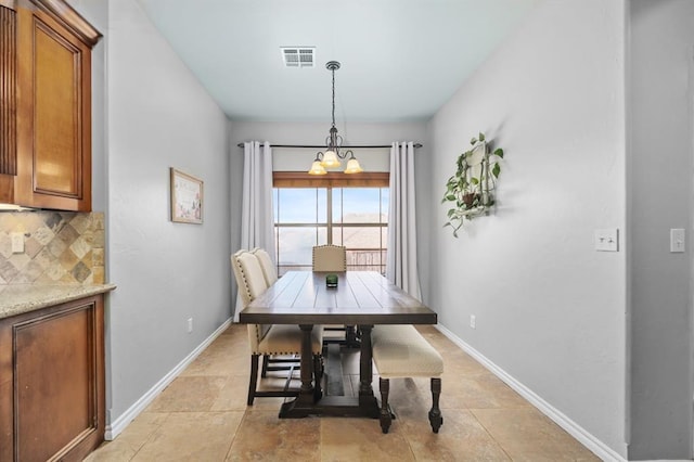 tiled dining space featuring a notable chandelier