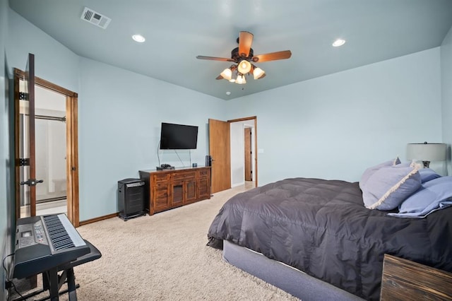 bedroom with ensuite bathroom, ceiling fan, and carpet flooring