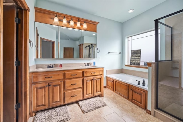 bathroom with vanity, tile patterned flooring, and separate shower and tub