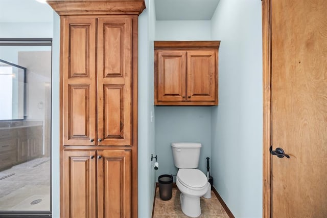 bathroom featuring walk in shower and toilet