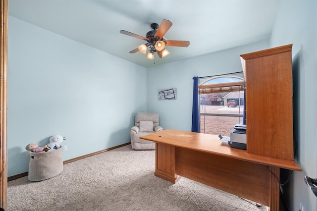 carpeted home office featuring ceiling fan