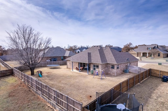 rear view of property with a playground and a patio