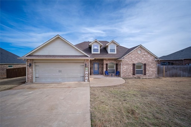 view of front of property with a garage and a front yard