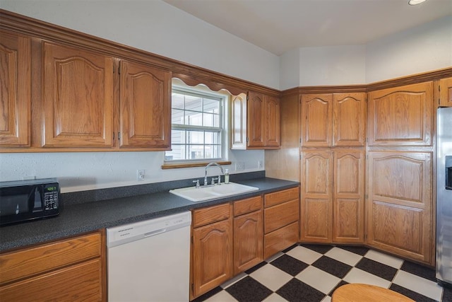 414315 E 1080th Rd, Checotah, OK 74426 - kitchen featuring dishwasher, black microwave, dark countertops, and brown cabinetry