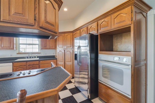 414315 E 1080th Rd, Checotah, OK 74426 - kitchen featuring white appliances, brown cabinets, dark countertops, recessed lighting, and light flooring