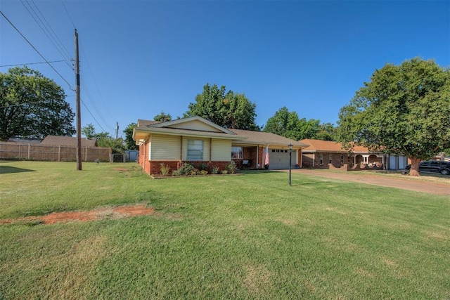 single story home with a garage and a front lawn