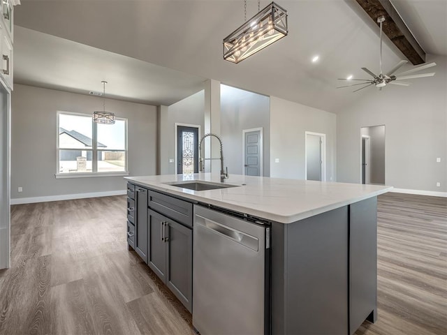 kitchen with lofted ceiling with beams, dishwasher, an island with sink, sink, and gray cabinetry