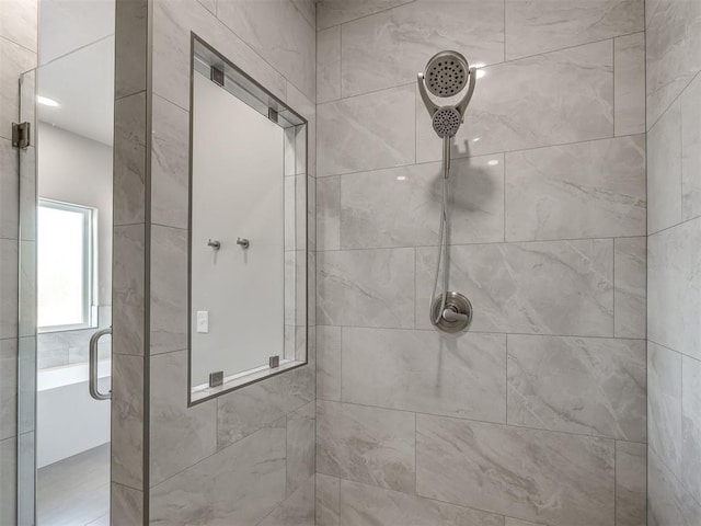 bathroom with a shower with door