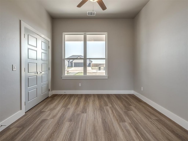 spare room with light hardwood / wood-style floors and ceiling fan