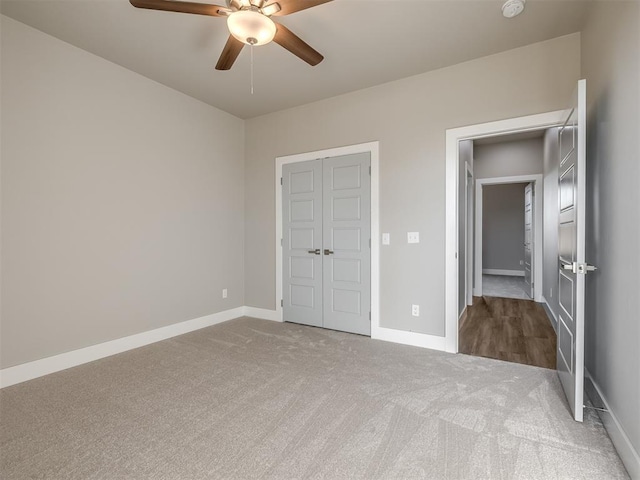 unfurnished bedroom featuring carpet floors and ceiling fan