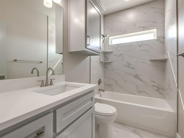 full bathroom featuring tiled shower / bath combo, vanity, and toilet