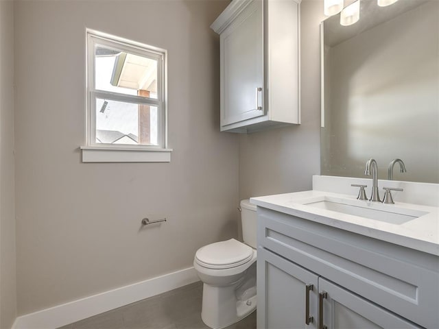 bathroom with vanity, tile patterned floors, and toilet