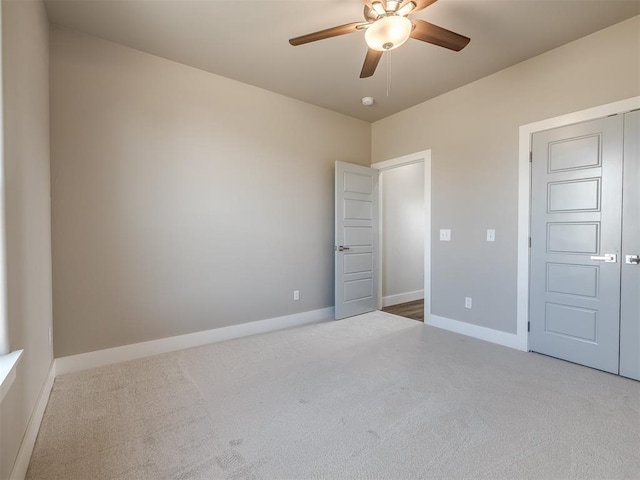 unfurnished bedroom with carpet, ceiling fan, and a closet