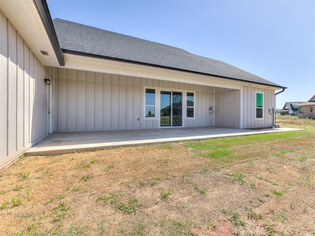 rear view of house featuring a yard and a patio area