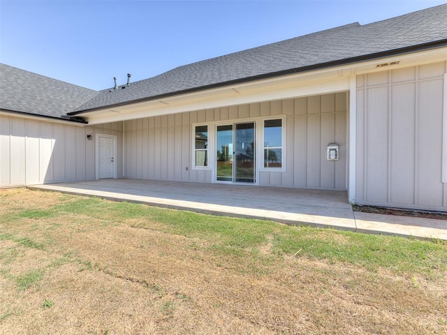 rear view of property featuring a yard and a patio area