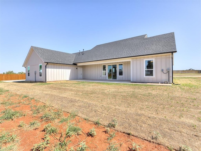 back of house with a lawn