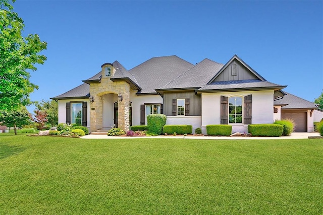 view of front of property featuring a garage and a front lawn