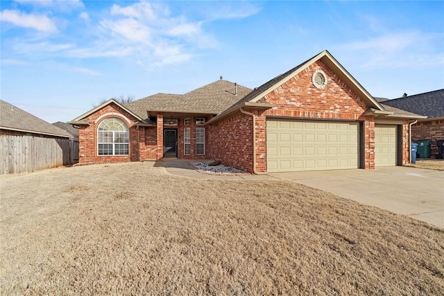 view of front of property with a garage and a front lawn