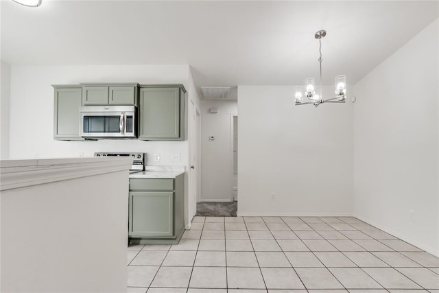 kitchen with a notable chandelier, decorative light fixtures, light tile patterned floors, and green cabinets