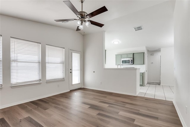 unfurnished living room with hardwood / wood-style floors and ceiling fan