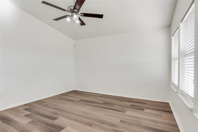 spare room featuring ceiling fan, lofted ceiling, and light hardwood / wood-style flooring