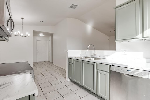 kitchen featuring sink, gray cabinets, appliances with stainless steel finishes, decorative light fixtures, and vaulted ceiling