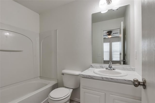 full bathroom featuring ceiling fan, vanity, toilet, and washtub / shower combination