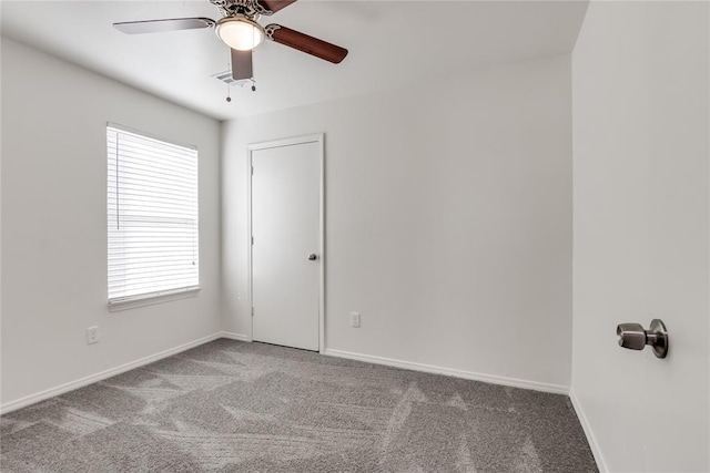 spare room featuring light carpet and ceiling fan