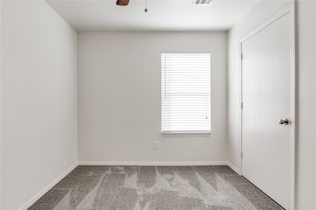 empty room with carpet floors and ceiling fan