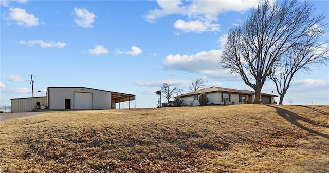 view of yard with a garage and an outdoor structure