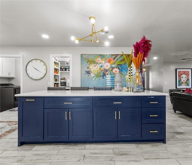 kitchen with open floor plan, light countertops, and blue cabinetry