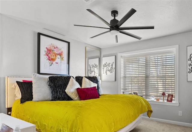 bedroom featuring baseboards, a ceiling fan, and light colored carpet