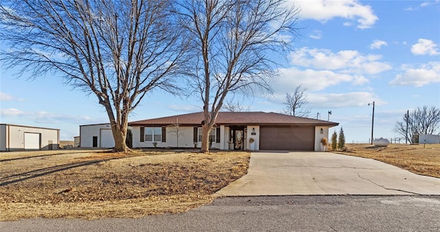 single story home featuring driveway, an attached garage, and stucco siding