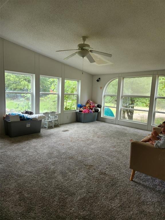 sunroom / solarium featuring ceiling fan and vaulted ceiling