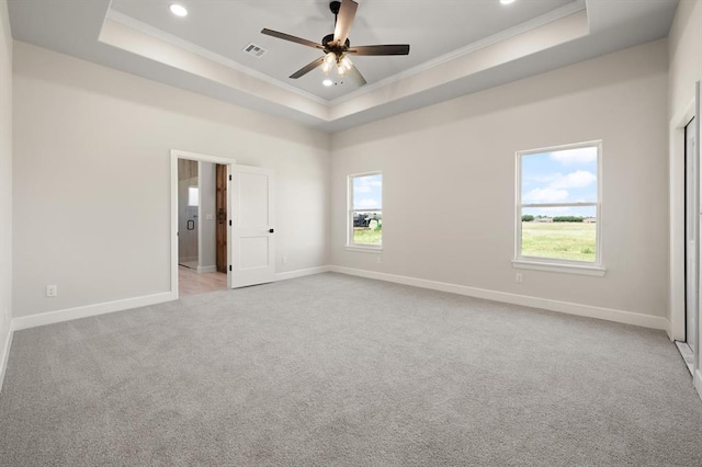 4341 Courtlyn Ave, Tuttle, OK 73089 - unfurnished bedroom featuring a raised ceiling, crown molding, multiple windows, carpet flooring, and recessed lighting