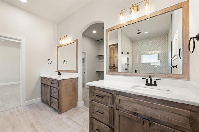 4341 Courtlyn Ave, Tuttle, OK 73089 - bathroom with two vanities, baseboards, and a tile shower
