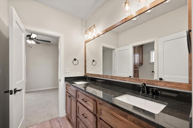 4341 Courtlyn Ave, Tuttle, OK 73089 - full bath featuring double vanity, wood finished floors, baseboards, and a ceiling fan
