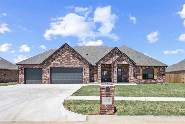 4341 Courtlyn Ave, Tuttle, OK 73089 - view of front of home with a garage, concrete driveway, brick siding, and roof with shingles