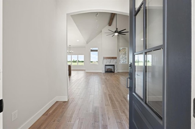 4341 Courtlyn Ave, Tuttle, OK 73089 - hallway featuring beam ceiling, light wood finished floors, baseboards, high vaulted ceiling, and a chandelier
