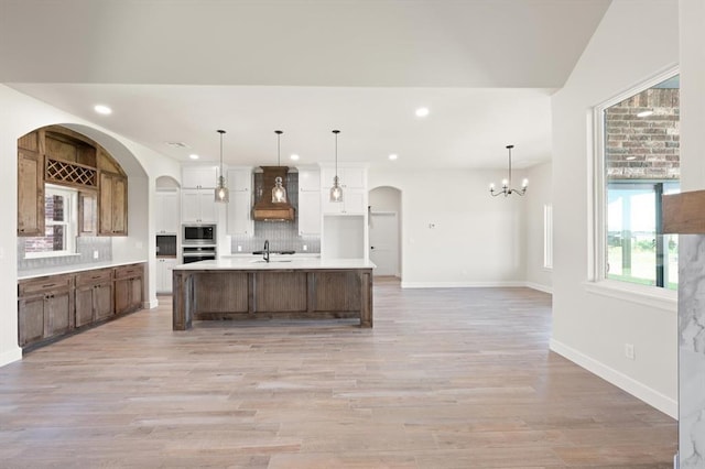4341 Courtlyn Ave, Tuttle, OK 73089 - kitchen featuring premium range hood, appliances with stainless steel finishes, a sink, decorative backsplash, and light countertops