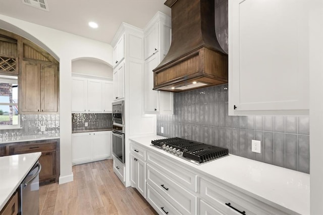 4341 Courtlyn Ave, Tuttle, OK 73089 - kitchen with custom range hood, appliances with stainless steel finishes, light countertops, white cabinetry, and recessed lighting