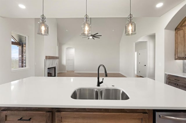 4341 Courtlyn Ave, Tuttle, OK 73089 - kitchen featuring a sink, arched walkways, stainless steel dishwasher, light countertops, and recessed lighting