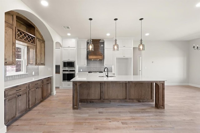 4341 Courtlyn Ave, Tuttle, OK 73089 - kitchen featuring custom range hood, a sink, stainless steel microwave, recessed lighting, and tasteful backsplash